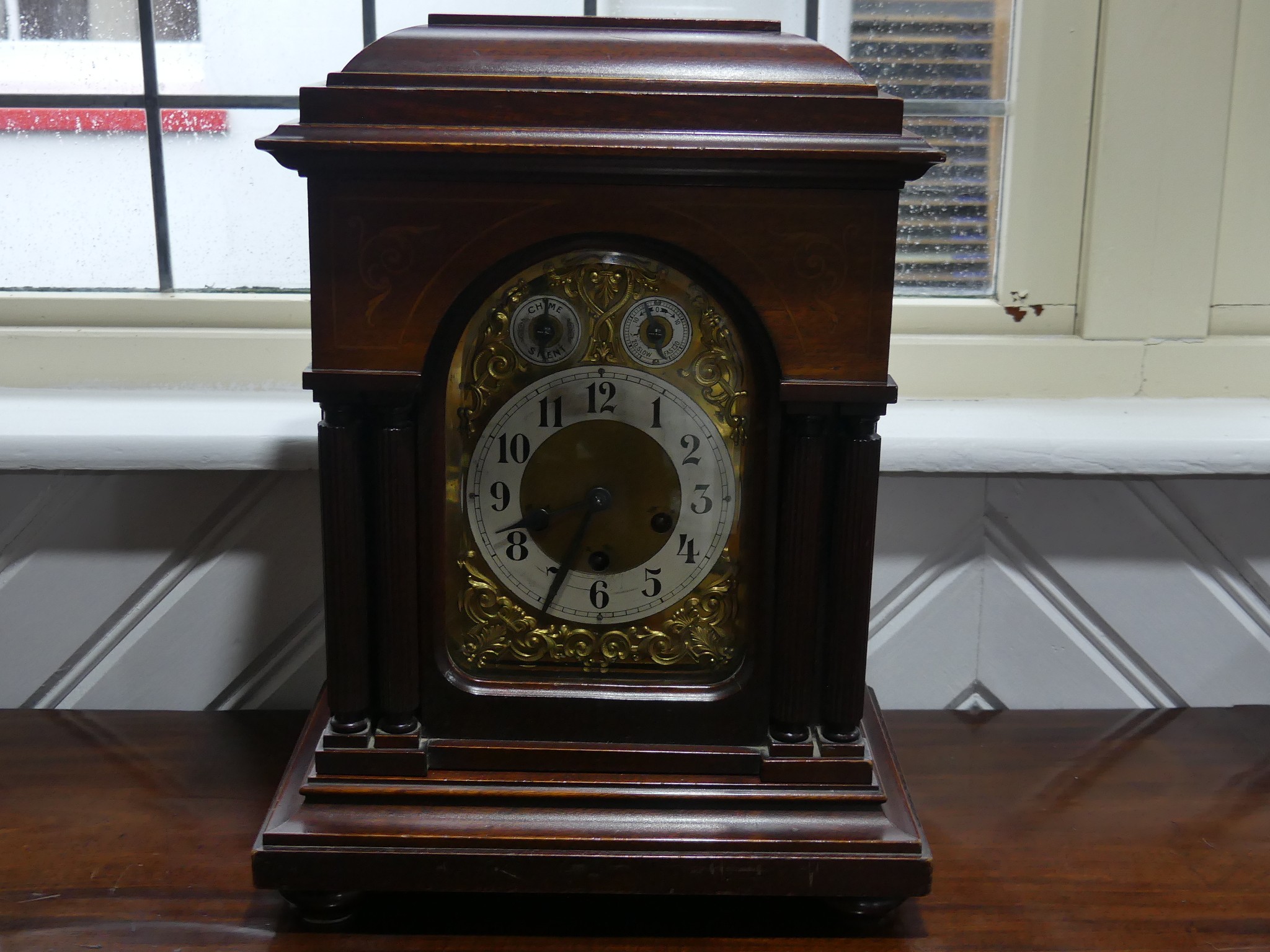 An early 20th century Junghans chiming Mantel Clock, the brass ached dial with silvered chapter ring