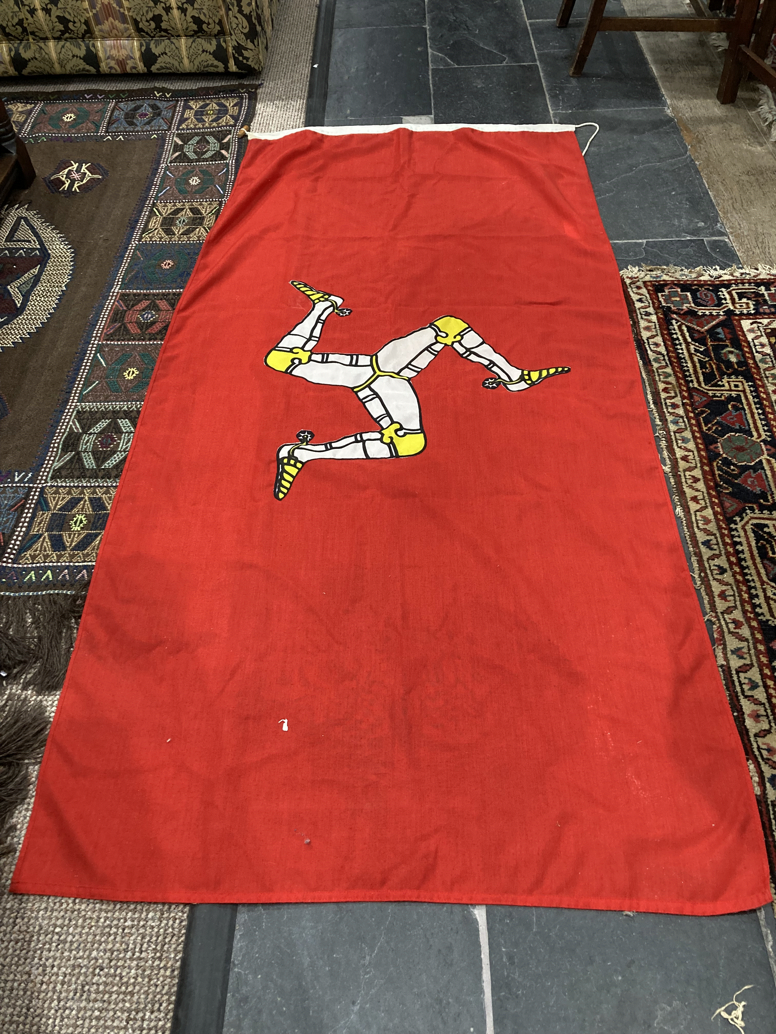 A vintage Isle of Man Flag, with appliqued symbol 35in x 68in (89cm x 173cm)