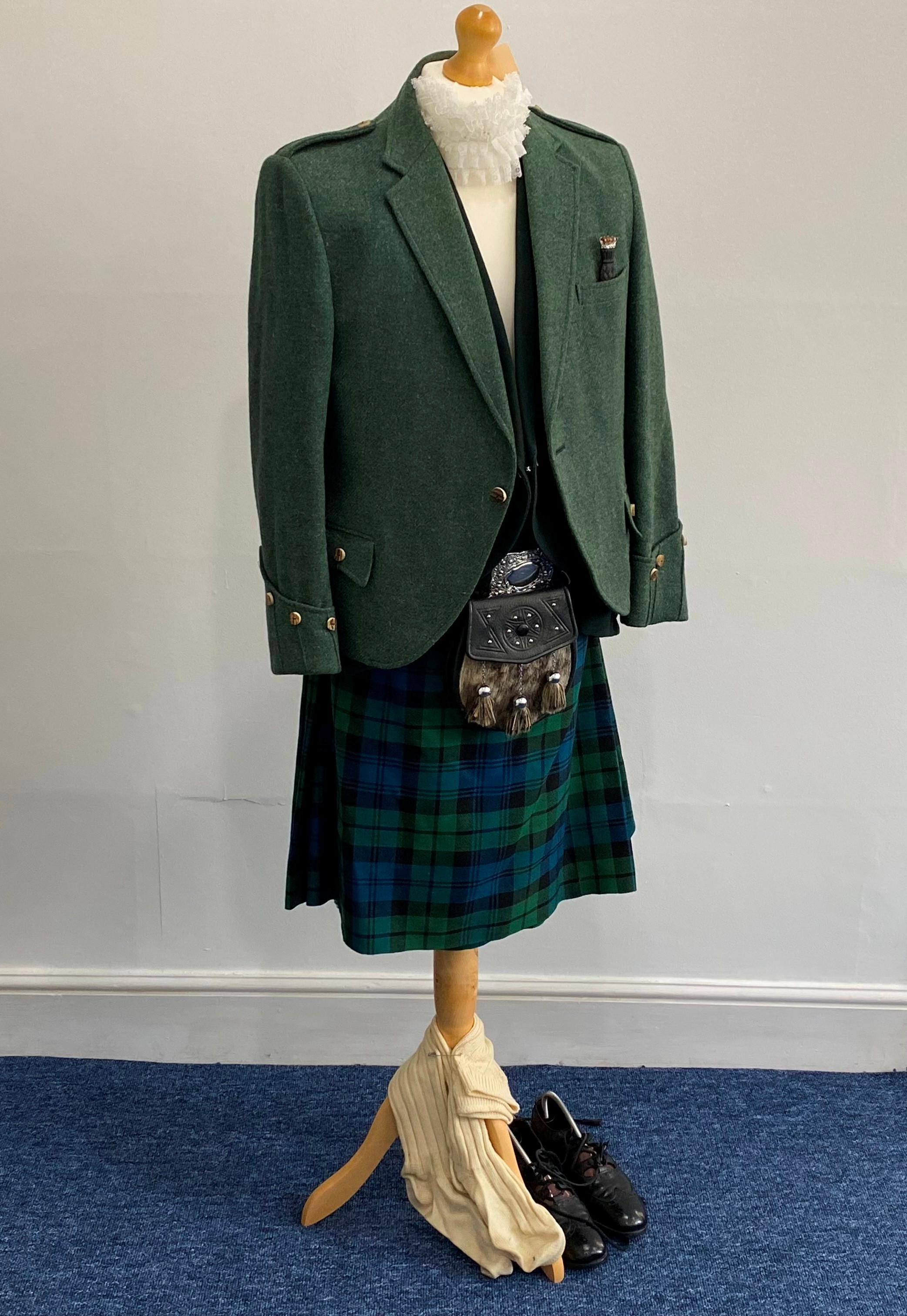 A mid 20thC Campbell Tartan Highlanders Scottish Piper's Outfit, comprising kilt, bottle green twill