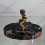 An early 20thC Paperweight, depicting a bronze Putti riding a Tortoise, the base painted to marble