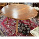 A vintage Ercol circular Table, raised on four circular legs with sticker, 44in (112cm) diameterx28n