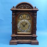 An early 20th Century oak three-train chiming bracket / mantel clock by Winterhalder & Hoffmeier,