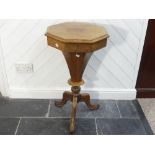 An early 20thC oak Sewing Table, of octagonal form, with fitted interior, on tripod base, 16½ (42cm)