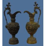 A near pair of Neoclassical Bronze Ewers, the two with body heavily decorated with cherubic figures,