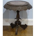 An early 20thC Anglo-Indian circular hardwood Tripod Table, the profusely carved top raised on a