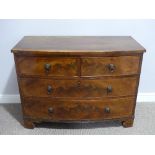 An early 20thC mahogany bow front Chest of Drawers, two short above two long, with turned handles,