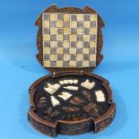 A boxed Isle of Lewis Chess Set, in the celtic style, with games board cover.