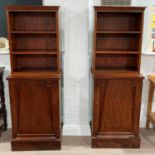 A pair of mid-20th century mahogany Upright Bookcases, the top with open shelving upon door