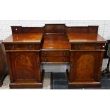 An Edwardian mahogany breakfront Sideboard, with two central drawers flanked by further drawers