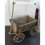 Garden Furniture; a vintage wooden rolling Dog Cart, 26in high x 43in deep x 28¾ wide (