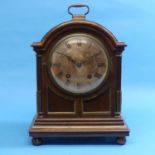 Early 20th century walnut cased chimimg Bracket Clock, of arched form with circular silvered dial