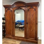 A Victorian mahogany Compactum Wardrobe, the moulded top and dentile cornice above central