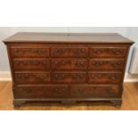 A large George III oak and crossbanded Mule Chest, the hinged fall with vacant interior, masked by