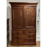 A Victorian mahogany Linen Press, the top with two doors enclosing drawers, upon two short and two