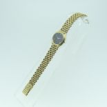 A 9ct yellow gold lady's Tissot Wristwatch, on 9ct gold bricklink bracelet, watch seized and does