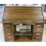 An early 20thC oak Tambour-front Roll Top Desk, by M. W. Edgley & Co, the rolling top exposing