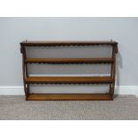 An Art Nouveau mahogany Wall hanging Shelf, with open shelves and dust covers 39in (99cm) wide x