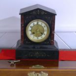 A Victorian black slate and brown marble Mantel Clock, of architectural form with circular dial,