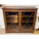 A Victorian mahogany glazed Bookcase, the incised top, upon astragal glazed doors, all raised on