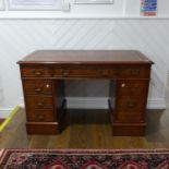 A Georgian-style elm Pedestal Desk, the top with leather inset above one central drawer, flanked