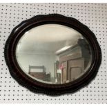 A wooden framed Wall Mirror, of ovular form, with moulded edge, 25in (63cm) wide