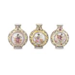 A SET OF THREE CHINESE FAMILLE ROSE SNUFF BOTTLES.