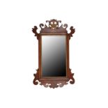 A GEORGE III STYLE WALNUT AND PARCEL GILT FRETWORK PIER MIRROR, LATE 19TH/EARLY 20TH CENTURY