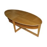 A CONTEMPORARY OVAL SOLID OAK AND OAK VENEERED ON CHIPBOARD COFFEE TABLE