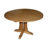 A CONTEMPORARY CIRCULAR OAK DINING TABLE