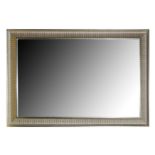 A CONTEMPORARY RECTANGULAR MIRROR WITH A GILT CUSHION FRAME