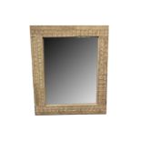 A CONTEMPORARY SPANISH LIMED OAK AND CHIP-CARVED WALL MIRROR