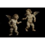 A PAIR OF LATE 17TH / EARLY 18TH CENTURY SOUTH GERMAN CARVED AND PAINTED WOOD PUTTI