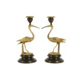 A PAIR OF GILT AND PATINATED BRONZE STORK CANDLESTICKS IN THE MANNER OF THOMAS ABBOTT