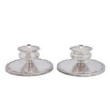 A pair of Elizabeth II combination dwarf candlesticks and tapersticks, Sheffield 1957 by Walker and