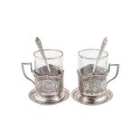 A pair of mid-20th century Iranian (Persian) silver tea glass holders, coasters and spoons, Isfahan