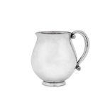 An early 20th century Danish sterling silver cream jug, Copenhagen by Georg Jensen, import marks for