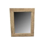 A CONTEMPORARY SPANISH LIMED OAK AND CHIP-CARVED WALL MIRROR