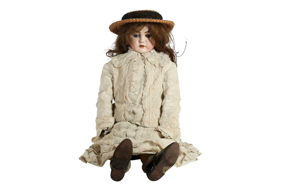 DOLLS: A CONTINENTAL PORCELAIN BISQUE HEAD DOLL, POSSIBLY BY KESTNER