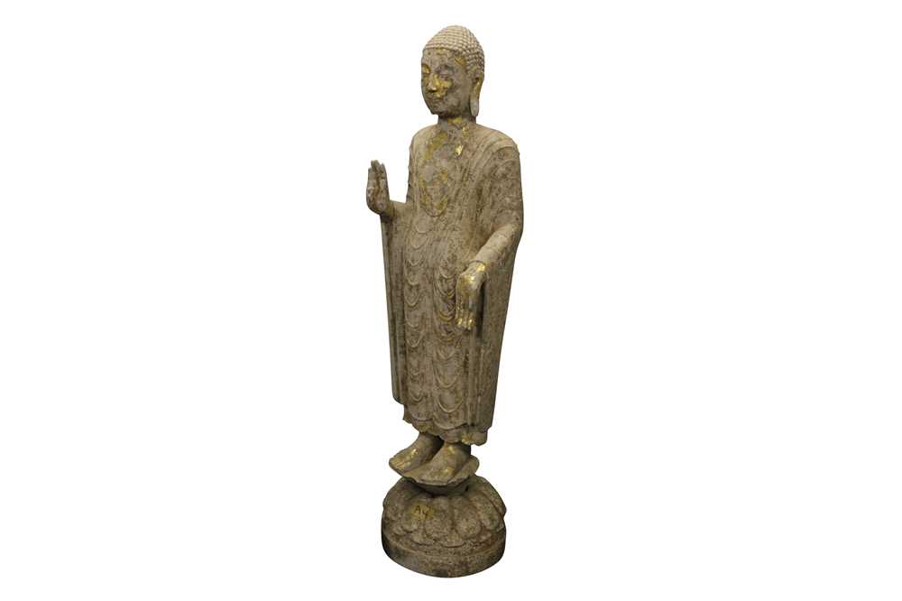 A CHINESE GILDED STONE FIGURE OF A STANDING BUDDHA