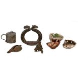 A GROUP OF FOUR COPPER-ALLOY INDIAN ELEMENTS AND THREE GLAZED EARTHENWARE OIL LAMPS India and North