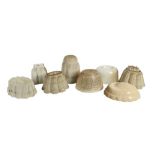 KITCHENALIA: EIGHT WHITE POTTERY JELLY MOULDS, LATE 19TH/EARLY 20TH CENTURY