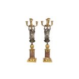 A PAIR OF 19TH CENTURY FRENCH EMPIRE STYLE GILT AND PATINATED BRONZE CANDELABRA
