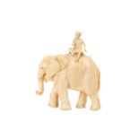 AN EARLY 20TH CENTURY JAPANESE CARVED IVORY OKIMONO OF AN ELEPHANT AND RIDER