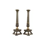 A LARGE PAIR OF EARLY 19TH CENTURY REGENCY BRONZE AND PARCEL GILT CANDLESTICKS