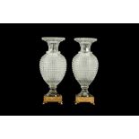 A PAIR OF EARLY 20TH CENTURY ORMOLU AND CUT GLASS VASES, POSSIBLY BACCARAT
