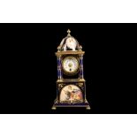 AN EARLY 20TH CENTURY VIENNESE PORCELAIN AND GILT BRASS MANTEL CLOCK