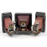 Three Folding Maroon Bellows Cameras.