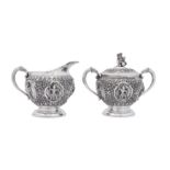An early 20th century Burmese unmarked silver milk jug and covered twin handled sugar bowl, Thayetmy