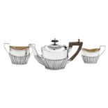 An Edwardian sterling silver bachelor three-piece tea service, Birmingham 1907/08 by William Aitken