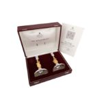 A cased pair of Elizabeth II parcel gilt sterling silver commemorative candlesticks, London 1977 by